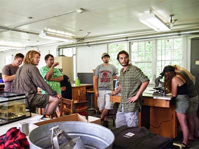 Chris Nack teaching aquatic sampling techniques with Dr. Stephanie Johnson