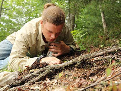 Joseph Benz looking at leaf litter