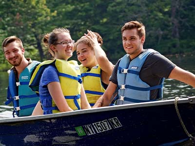 Devan Wade, Ryan Goodman, Christa Dock and Dominic Castiglia in a motor boat