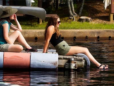 Laura Pickering and Breanna Reilly soak up sun on the dock