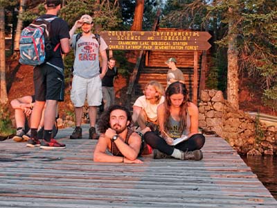 Students watching sun set over the lake