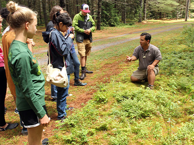 Neil Patterson teaches campers about using items found in nature to make Native American crafts