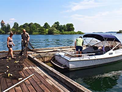 Seniors Mia Cipullo and Siddarth “Sid” Motwani dry a net in a sunny spot on the dock.