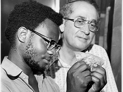 Student and faculty looking at a sample