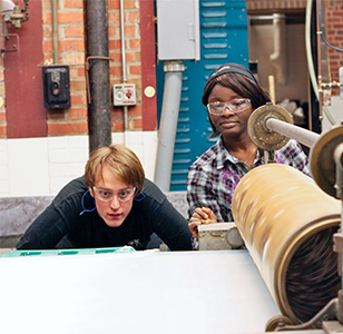students inspecting the paper run