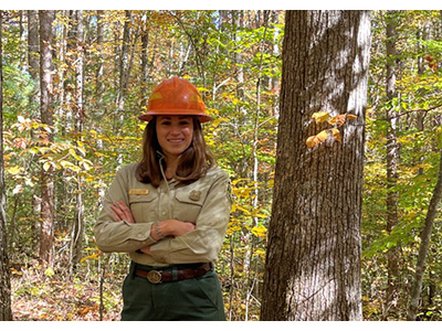 Kelly Corbine in a hard hat and Forester uniform