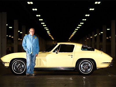 Bob Kinstrey standing next to yellow car