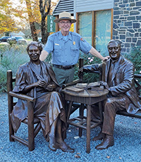 David Hayes standing next to statues