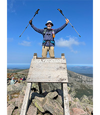 Gerry Madigan standing at the top of Katahon Mountail with his walking sticks