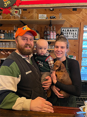 Maggie Bennett and Harrison Cox with their son Haywood Cox and a dog