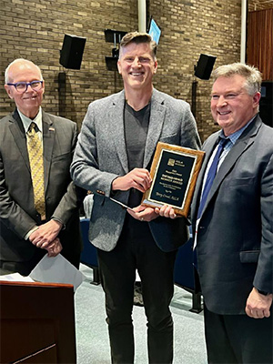 Terrance Croad holding an award from 2023 Michigan Chapter, American Society of Landscape Architects