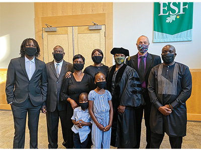 Charity Nyelele with her family and Dr. Charles Kroll