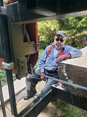 Norman baker leaning against a timber