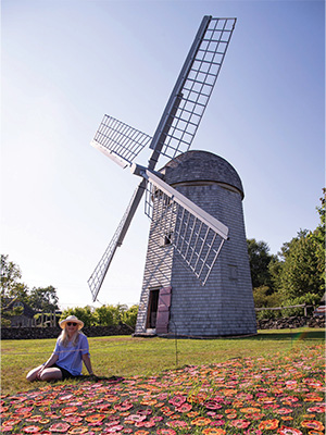Eileen Travis siting in front of the historic Windmill in Jamestown, RI